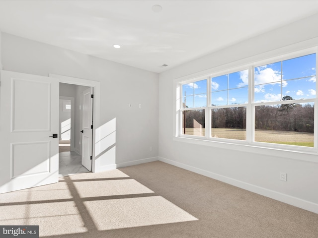 spare room featuring light colored carpet