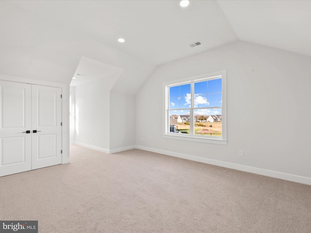 bonus room featuring light carpet and lofted ceiling