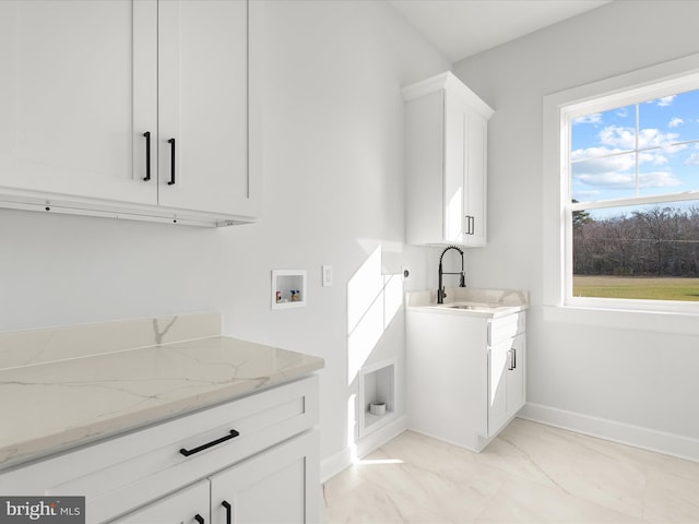 laundry area with cabinets, washer hookup, and sink