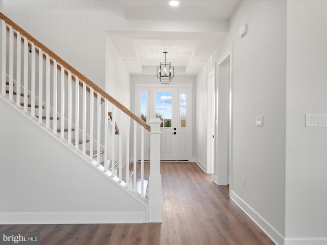 foyer featuring hardwood / wood-style floors and a notable chandelier