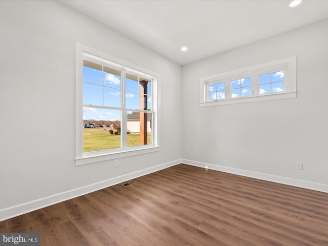 unfurnished room with dark wood-type flooring