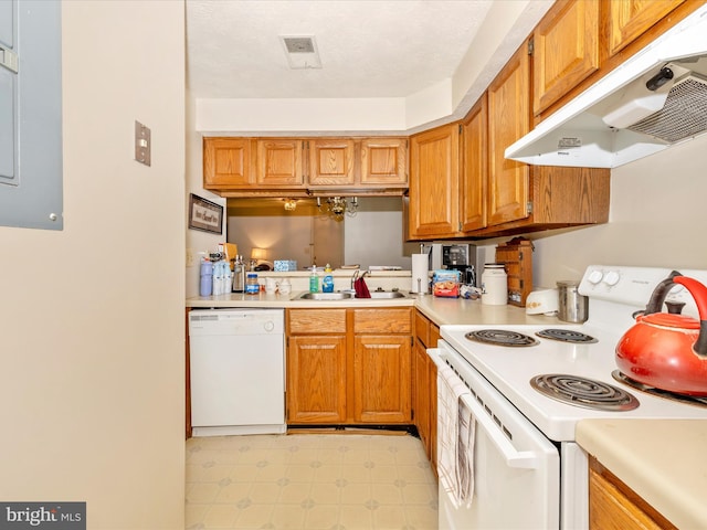 kitchen with sink, white appliances, and a textured ceiling