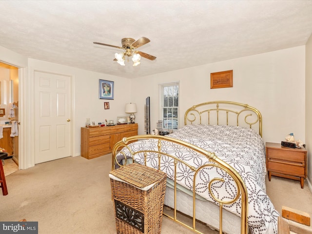 bedroom with light carpet, ceiling fan, and a textured ceiling