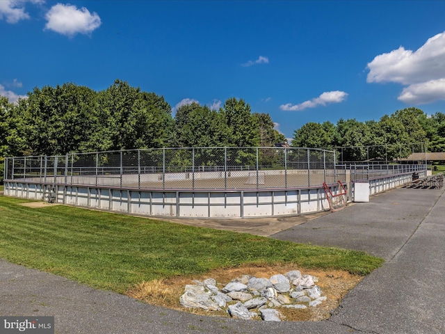 view of pool featuring a yard