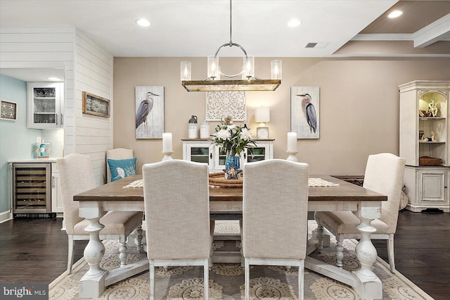 dining room with a notable chandelier, dark hardwood / wood-style flooring, crown molding, and wine cooler