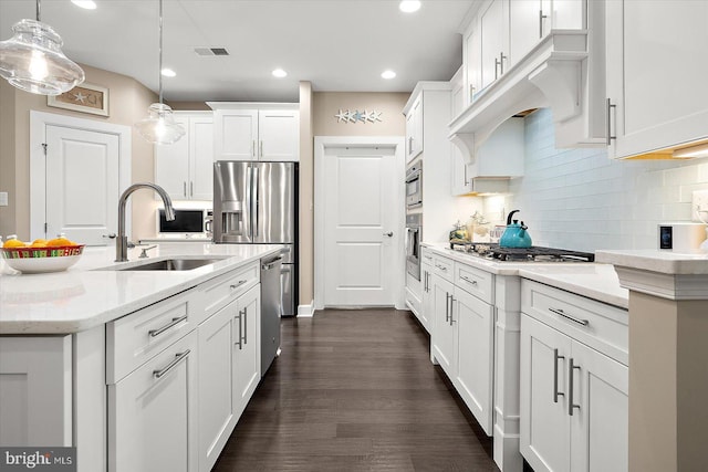 kitchen featuring sink, light stone countertops, decorative light fixtures, dark hardwood / wood-style flooring, and white cabinetry