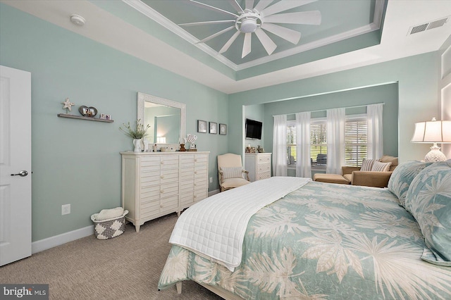 carpeted bedroom featuring a raised ceiling, ceiling fan, and crown molding