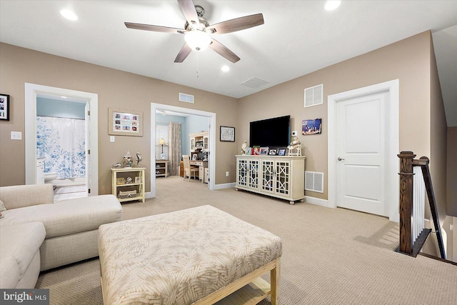 carpeted living room featuring ceiling fan