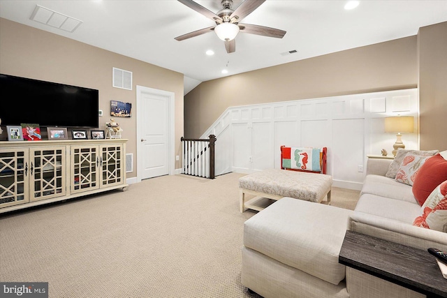 carpeted living room with ceiling fan