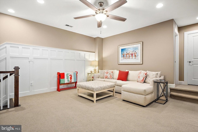 living room with ceiling fan and light colored carpet