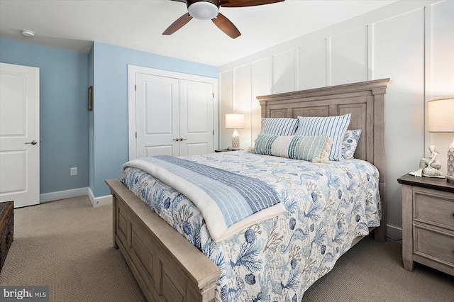 carpeted bedroom with ceiling fan and a closet