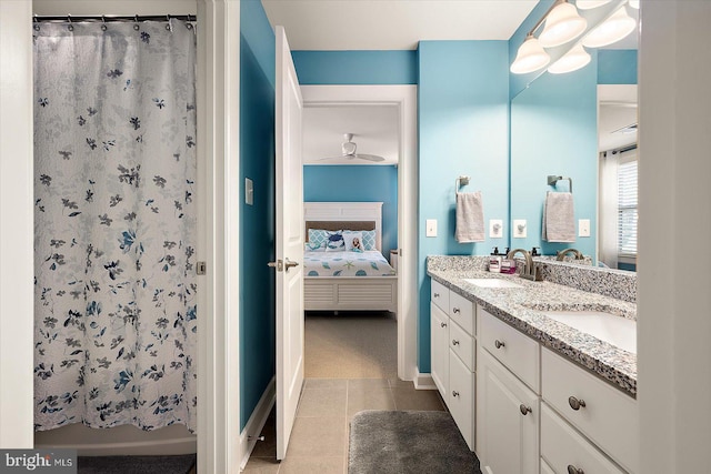 bathroom with curtained shower, ceiling fan, tile patterned flooring, and vanity