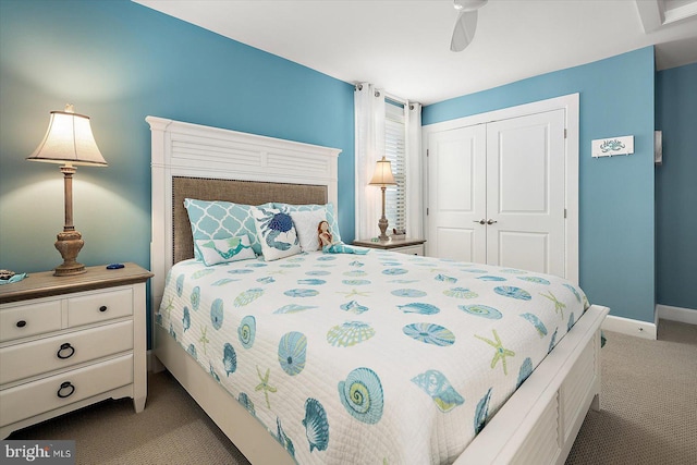 carpeted bedroom with ceiling fan and a closet