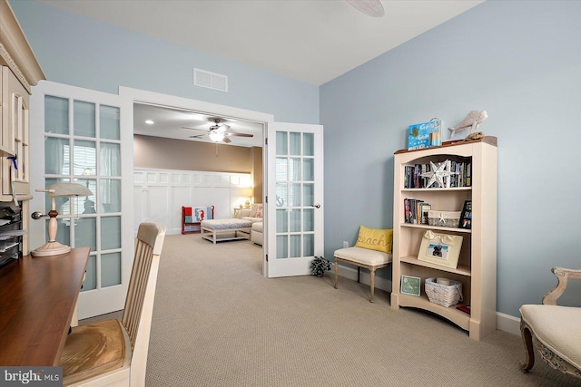 sitting room with ceiling fan, carpet floors, and french doors