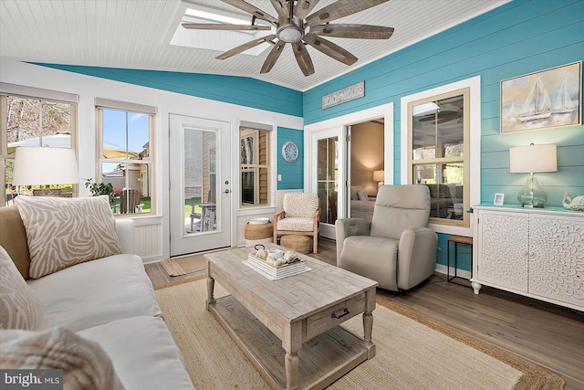 sunroom / solarium with lofted ceiling with skylight and ceiling fan