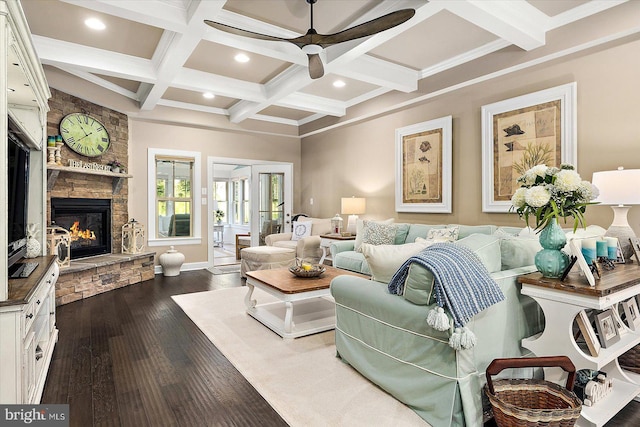 living room featuring beam ceiling, ceiling fan, coffered ceiling, hardwood / wood-style floors, and a fireplace