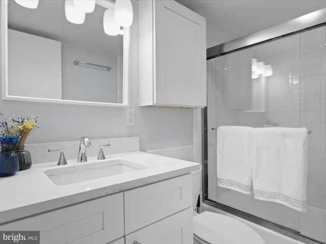 full bathroom with vanity, toilet, and shower / bath combination with glass door