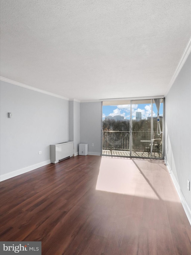 unfurnished living room with floor to ceiling windows, crown molding, dark hardwood / wood-style flooring, and a textured ceiling