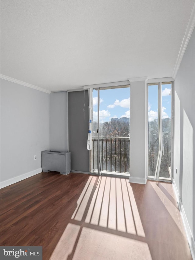 interior space with crown molding, expansive windows, and hardwood / wood-style flooring