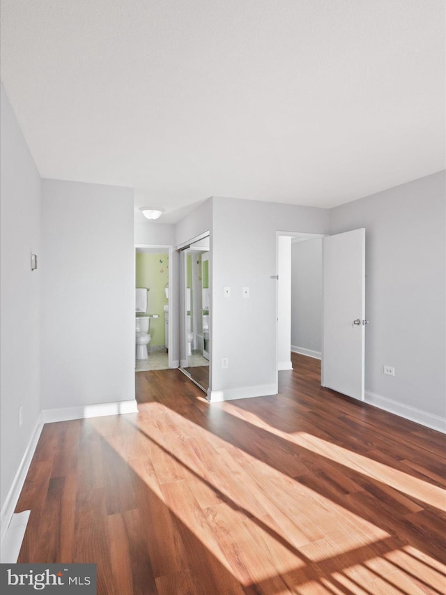 unfurnished room with dark hardwood / wood-style floors