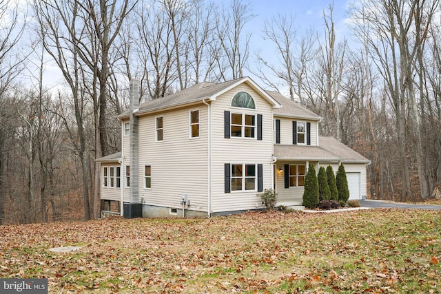 view of property with a garage and cooling unit