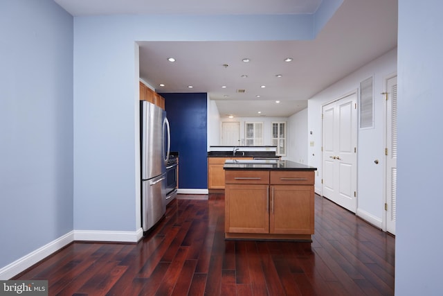 kitchen with decorative backsplash, stainless steel fridge, sink, and dark wood-type flooring