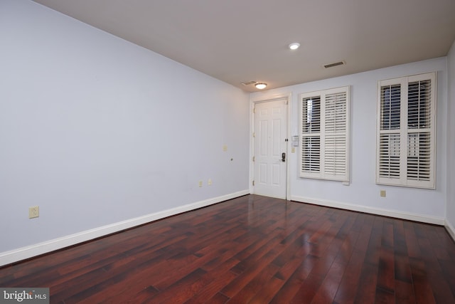 spare room with dark wood-type flooring