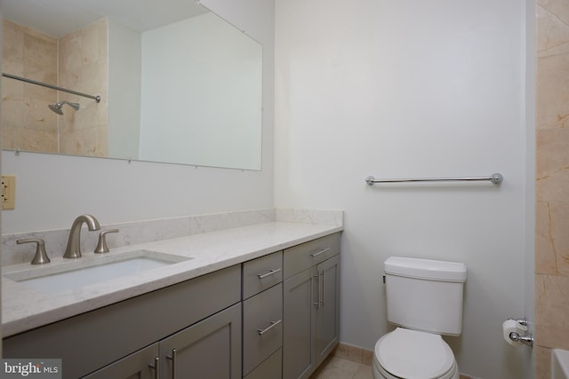 bathroom featuring tiled shower, tile patterned floors, vanity, and toilet