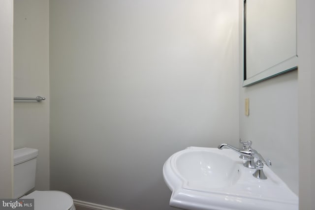 bathroom featuring sink and toilet