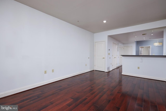 unfurnished living room featuring dark wood-type flooring