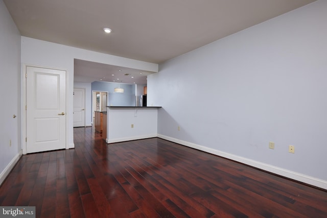 unfurnished living room featuring dark hardwood / wood-style flooring