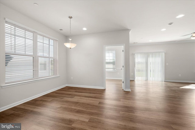 spare room with dark hardwood / wood-style floors and ceiling fan