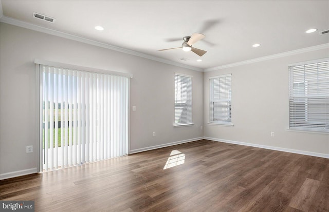 spare room featuring crown molding, ceiling fan, and dark wood-type flooring