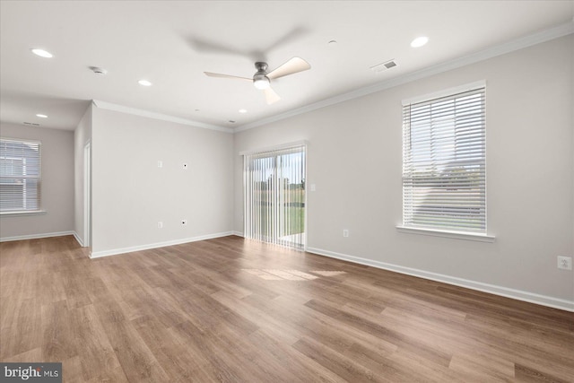 empty room with light wood-type flooring, ceiling fan, and crown molding