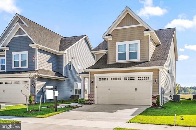 craftsman-style house featuring central air condition unit, a front yard, and a garage