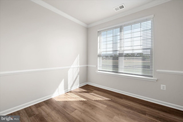 empty room with hardwood / wood-style flooring and ornamental molding