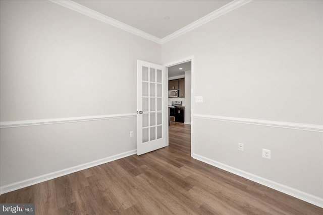 unfurnished room with french doors, hardwood / wood-style flooring, and crown molding