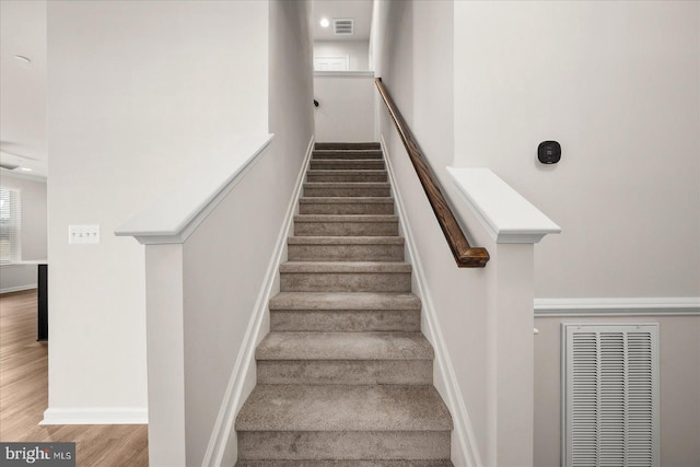 stairway with hardwood / wood-style flooring