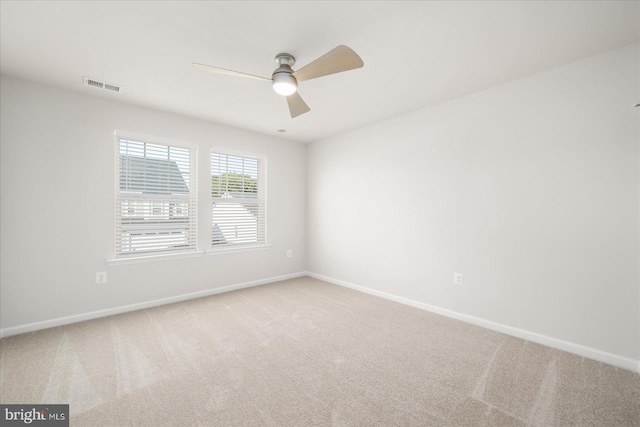 carpeted spare room featuring ceiling fan