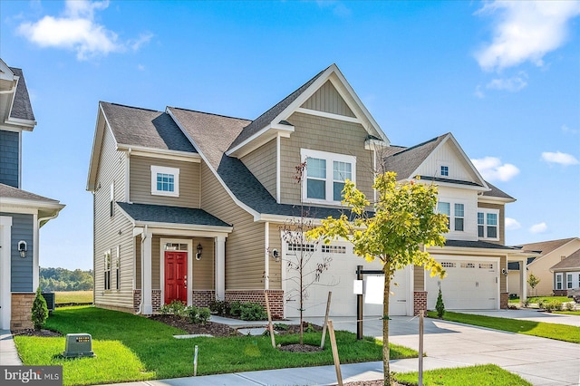 craftsman-style house featuring a front yard and a garage