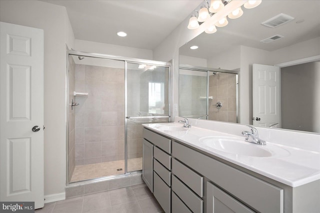 bathroom featuring tile patterned floors, vanity, and walk in shower