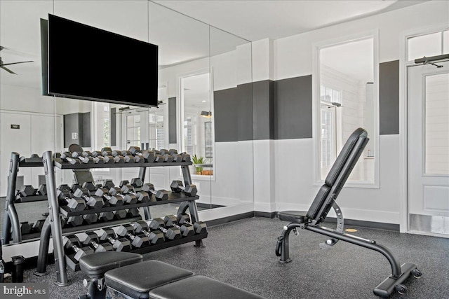 exercise room featuring ceiling fan and a healthy amount of sunlight