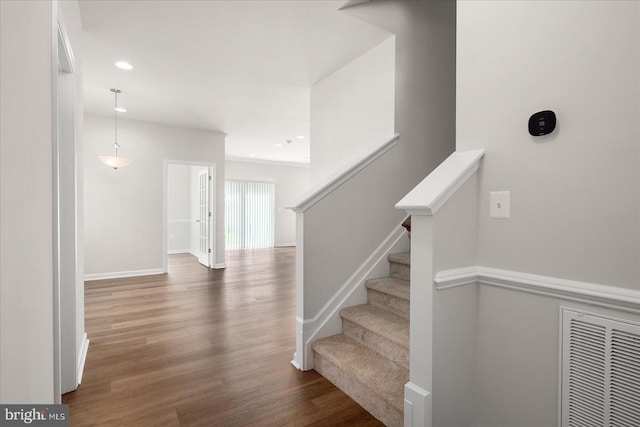 stairs with wood-type flooring