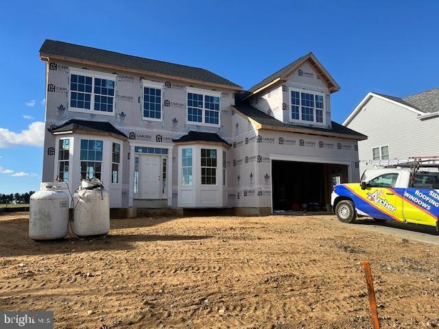 property in mid-construction with a garage