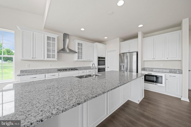 635 Corbit Dr, Middletown, DE 19709 - kitchen with wall chimney range hood, appliances with stainless steel finishes, a sink, white cabinetry, and dark wood-style floors