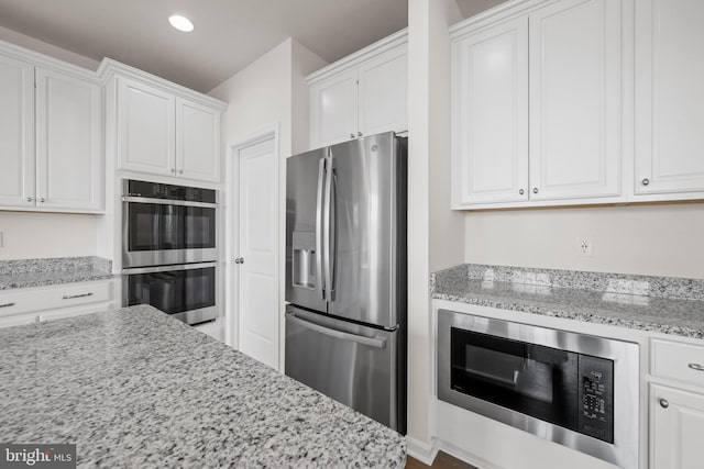 635 Corbit Dr, Middletown, DE 19709 - kitchen with stainless steel appliances, white cabinetry, light stone counters, and recessed lighting