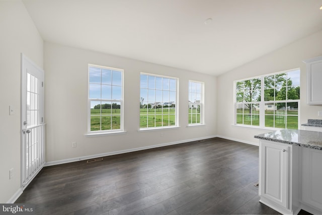 635 Corbit Dr, Middletown, DE 19709 - unfurnished living room with lofted ceiling, dark wood finished floors, and baseboards