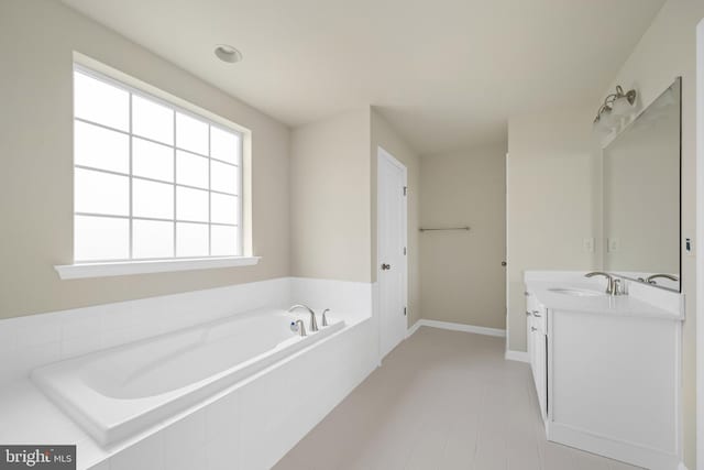 635 Corbit Dr, Middletown, DE 19709 - full bathroom featuring vanity, a garden tub, and baseboards