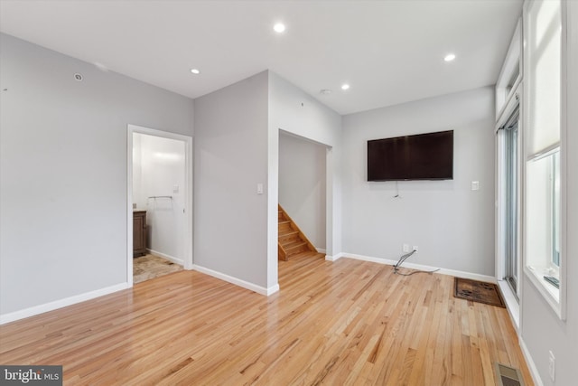 interior space with light wood-type flooring and connected bathroom