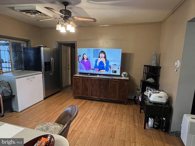 kitchen with ceiling fan, white fridge, stainless steel refrigerator with ice dispenser, and light hardwood / wood-style flooring